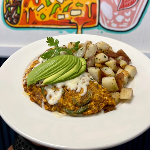 Aquino's Birrieria & Brunch's Mexican omelet with avocado, melted cheese, cilantro, and roasted potatoes.